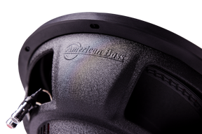 Close-up of an American Bass Audio DX 12" subwoofer from the Ground Pound Bundle, featuring the brand name embossed on its textured surface, visible wiring, and intricate speaker detailing—an ideal match for a setup with dual 12" subwoofers and the VFL Rebel REBEL-3000.1 monoblock amplifier.