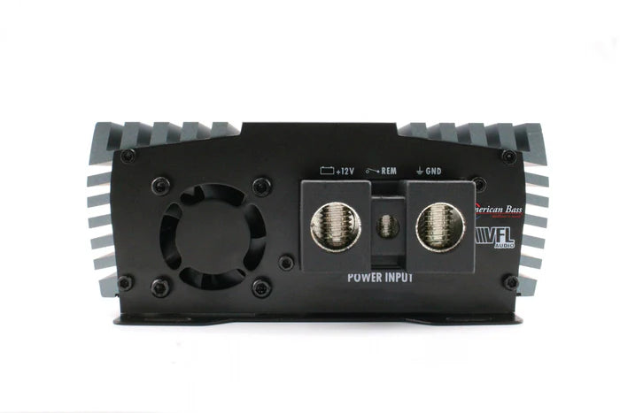A close-up of the American Bass Audio VFL Rebel REBEL-3000.1 amplifier’s back panel reveals power input terminals labeled 12V, REM, and GND, along with a fan vent and distinct branding, flanked by black and silver heat sinks—an ideal match for driving the Ground Pound Bundle’s dual DX 12" subwoofers.
